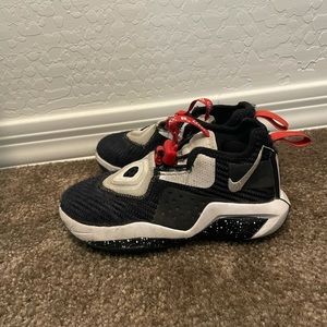 Kids black Nike shoes